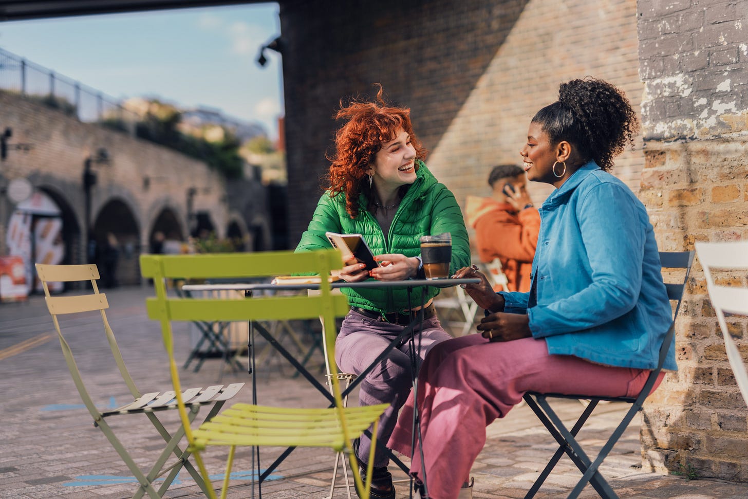 Two female friends chatting over coffee.