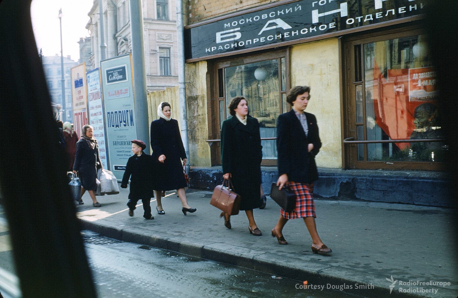 A candid street scene unfolds in central Moscow, revealing the everyday rhythm of 1950s Soviet life. A candid street scene unfolds in central Moscow, revealing the everyday rhythm of 1950s Soviet life.