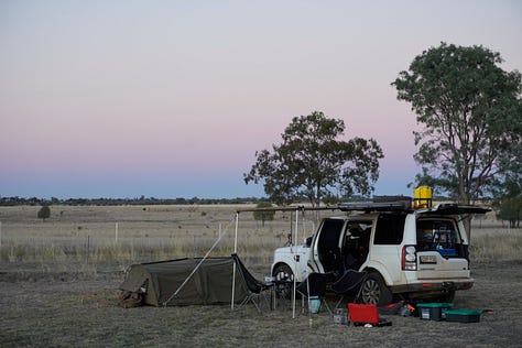 A collection of photos from an Australian outback expedition including a detailed travel map with route flags, a loaded 4WD vehicle on a red dirt road, and a sunset campsite in the desert.