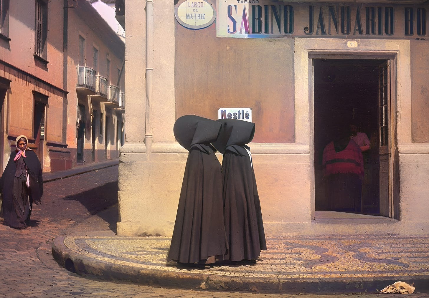 Two Azorean women dressed in black robes stand in front of a building looking like the characters from The Handmaid's Tale. Two Azorean women dressed in black robes stand in front of a building looking like the characters from The Handmaid's Tale.