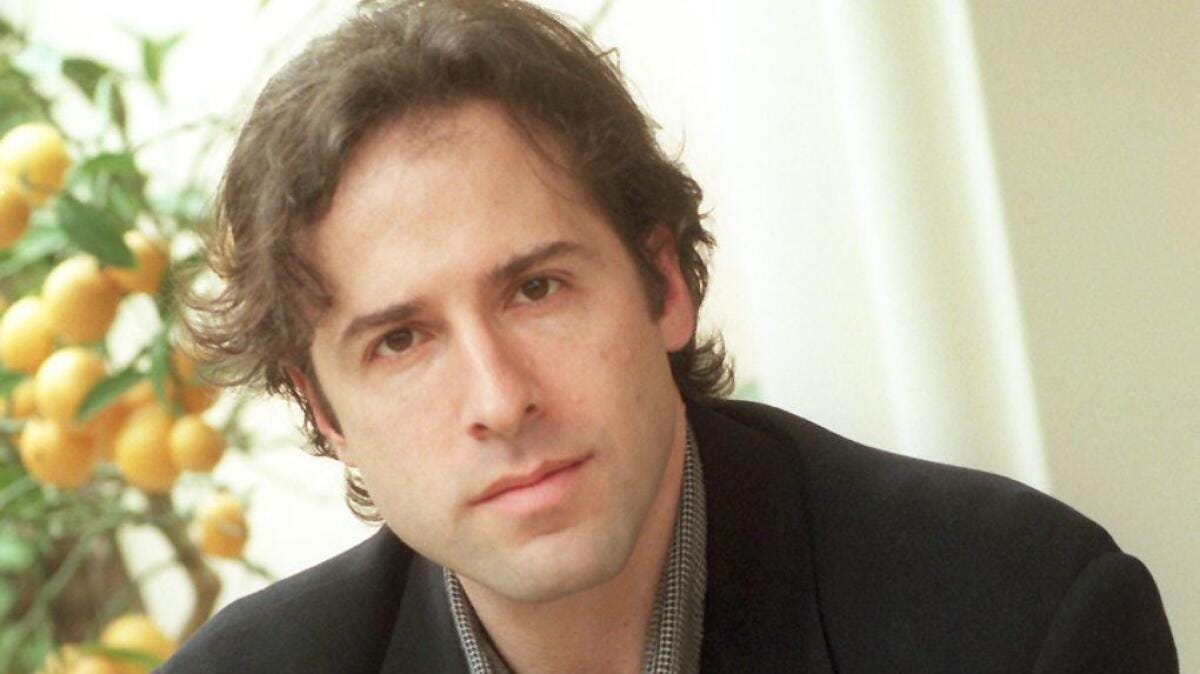 A 1996 photo of director David O. Russell for his film "Flirting With Disaster," described in the original caption as a "romantic screwball adoption comedy."