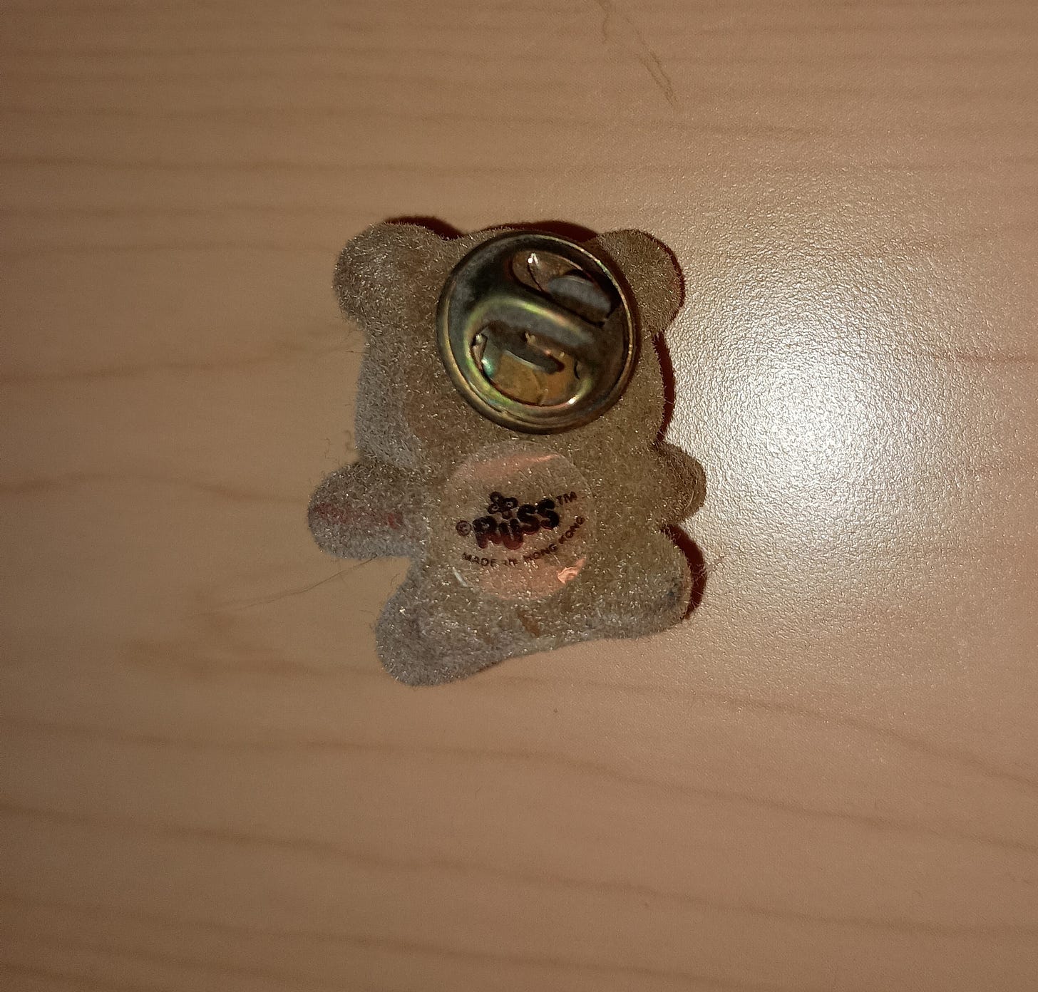 back of bear pin showing Russ sticker