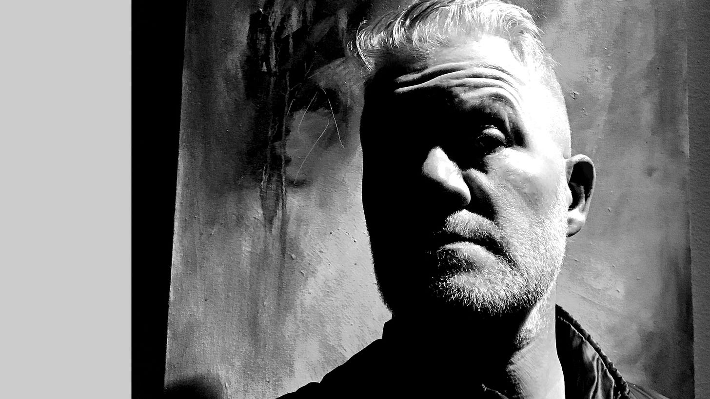 Image of Bert standing in front of a painting. Image of Bert standing in front of a painting.