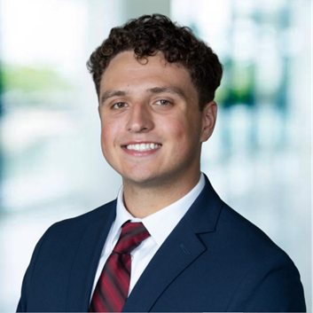 A person in a suit and tie

AI-generated content may be incorrect.