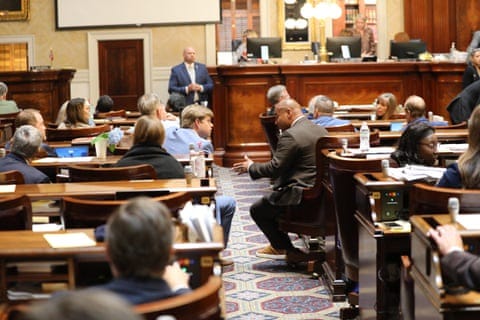 Republican Rep. Brandon Newton and Democratic Rep. Todd Rutherford talk across the aisle in a legislative chamber