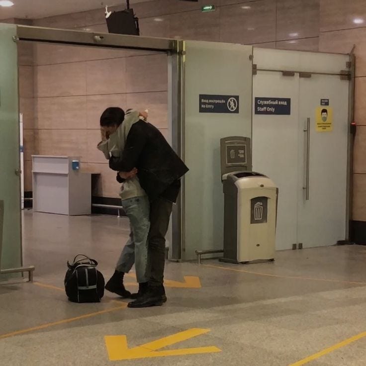 This may contain: a man standing in an airport with his luggage