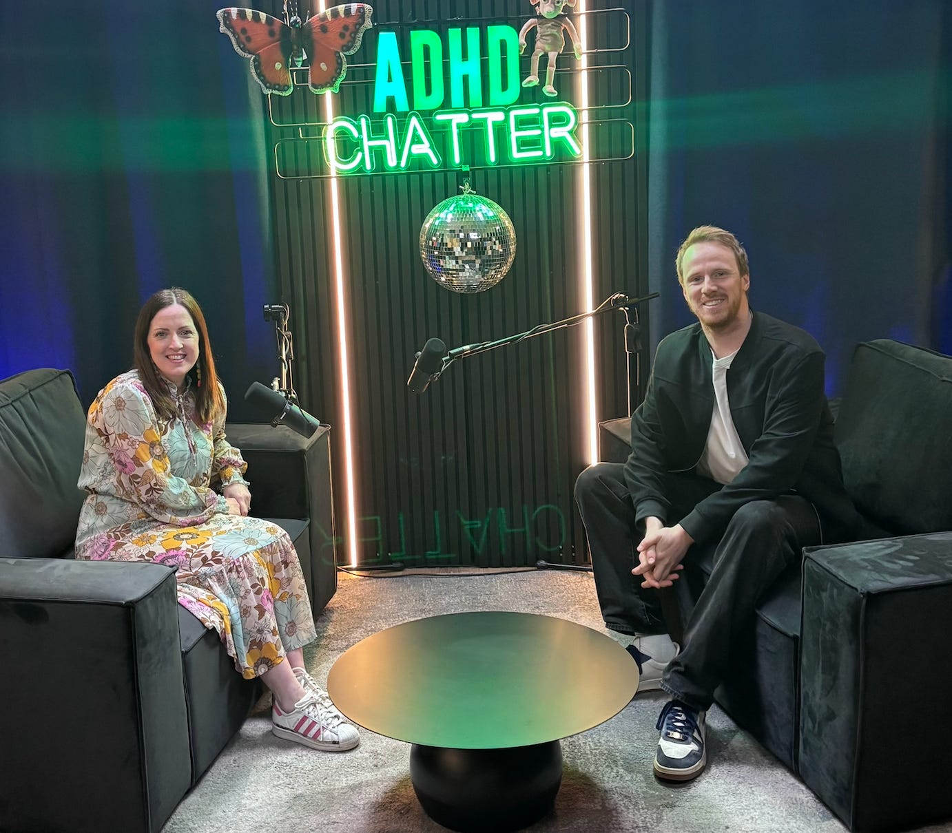 Image of a man and a woman sitting in ADHD Chatter podcast studio 