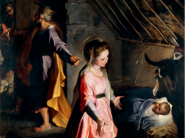 Nativity scene with Mary, Joseph, a cow, and Jesus in a manger
