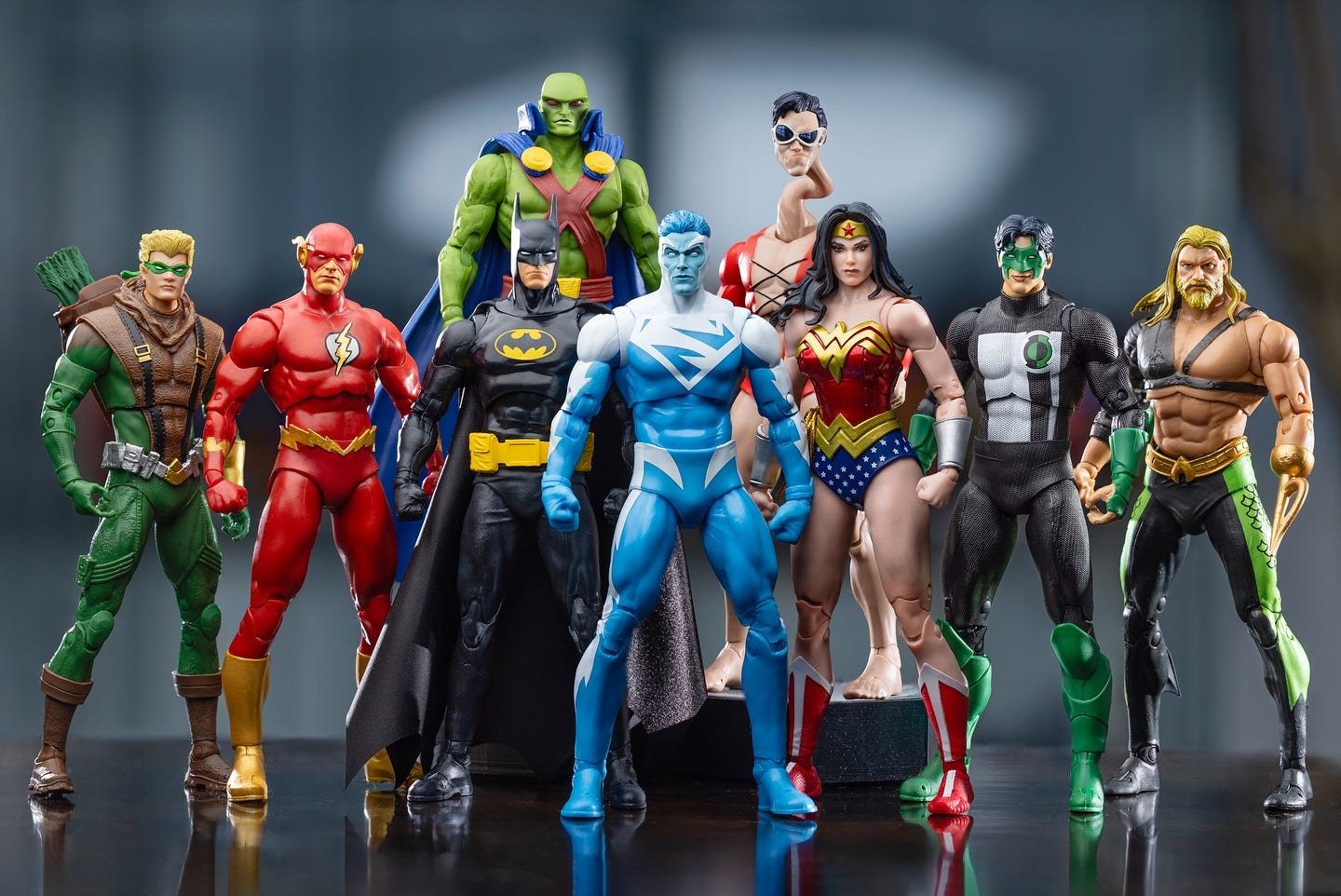 Toy versions of the JLA, Green Arrow, Flash, Batman, Superman, Martian Manhunter, Plastic Man, Wonder Woman, Green Lantern and Aquaman