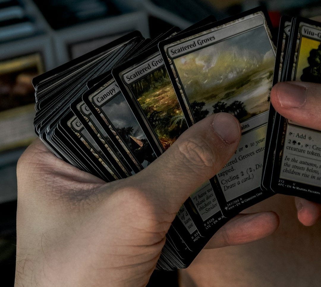 A person holding a bunch of cards in their hands