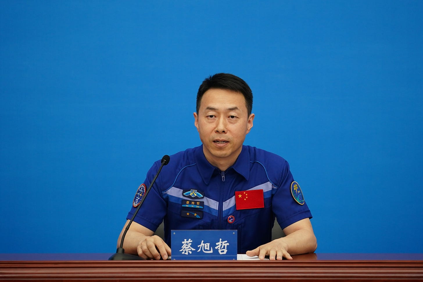 Shenzhou-19 Commander Cai Xuzhe speaks to the press.