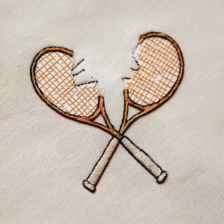 Painterly floral artwork with blurred brushstroke textures and muted romantic tones paired with hand-embroidered crossed tennis rackets on natural fabric, reflecting the rise of imperfect craftsmanship, tactile storytelling, soft nostalgia, and emotionally driven design aesthetics influencing fashion, interiors, branding, and lifestyle trends.