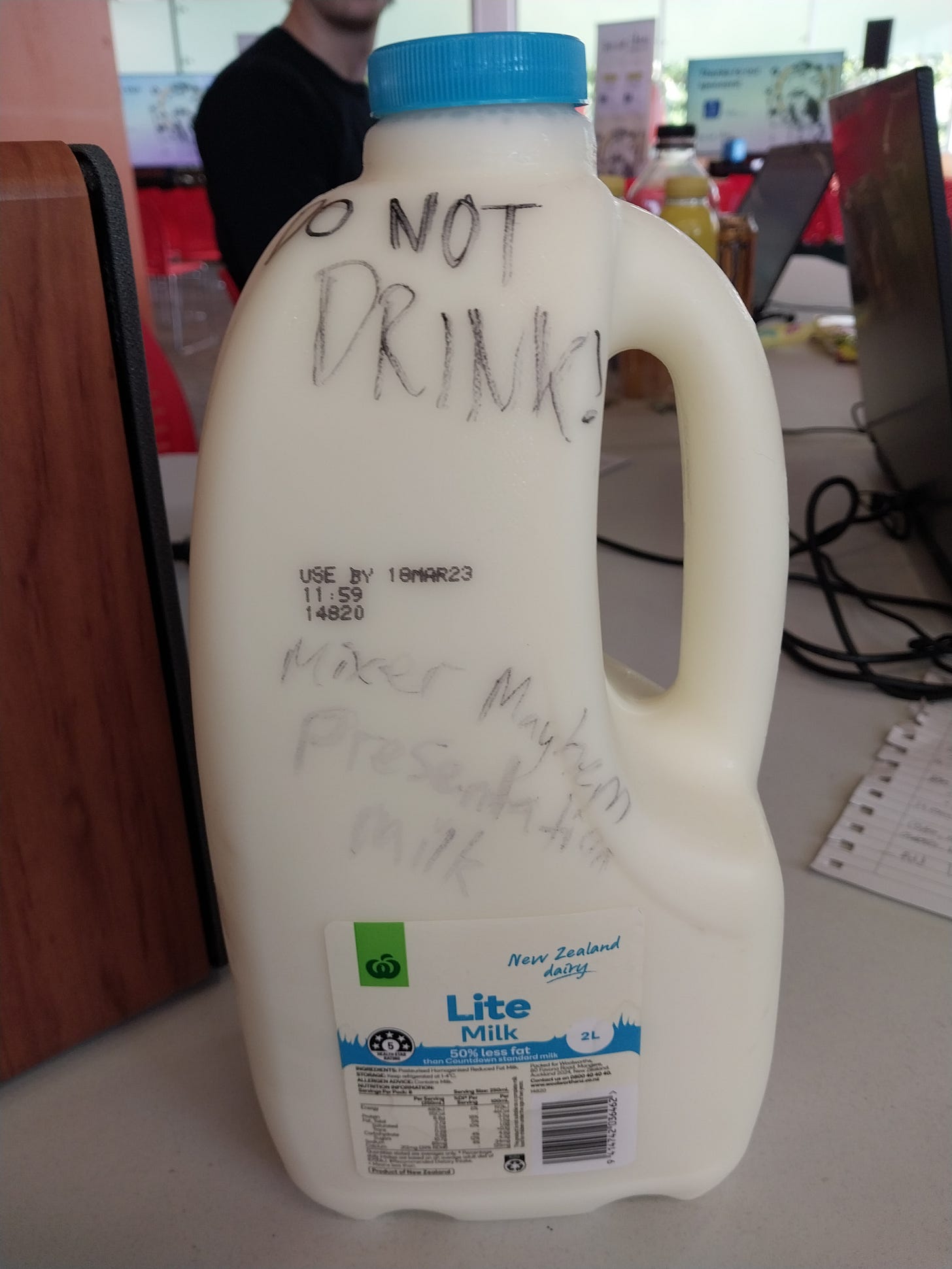 A milk bottle reading "DO NOT DRINK! Mixer Mayhem presentation milk." A milk bottle reading "DO NOT DRINK! Mixer Mayhem presentation milk."