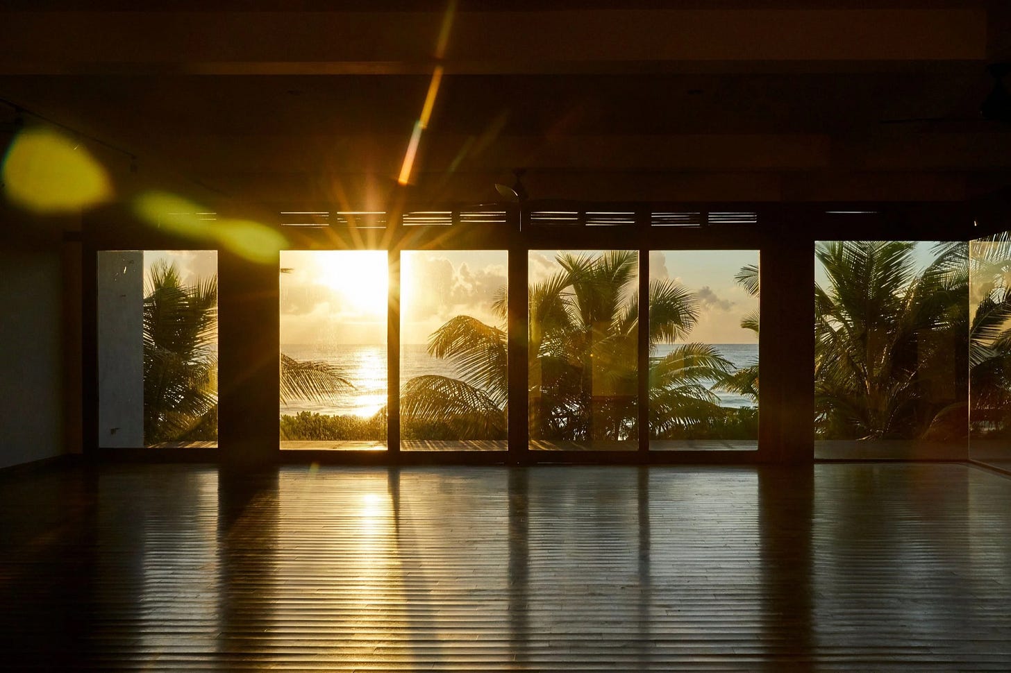 Sunrise through the shala at Sanará, the palms and the sea beyond Sunrise through the shala at Sanará, the palms and the sea beyond