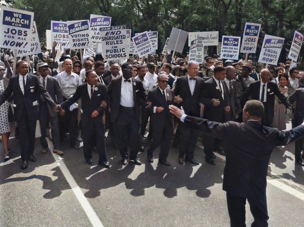 men in suit walking on street holding signages