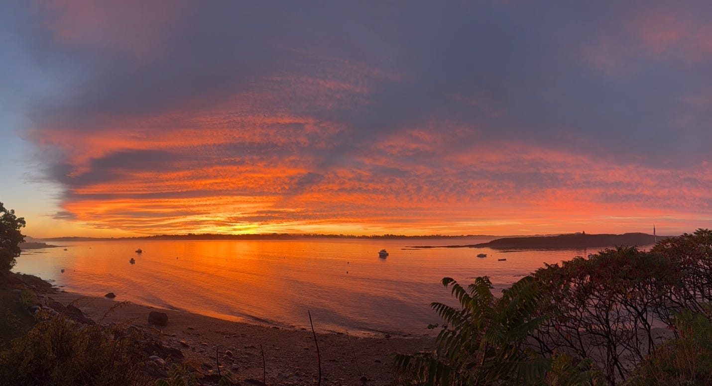 A sunset over a body of water

AI-generated content may be incorrect.