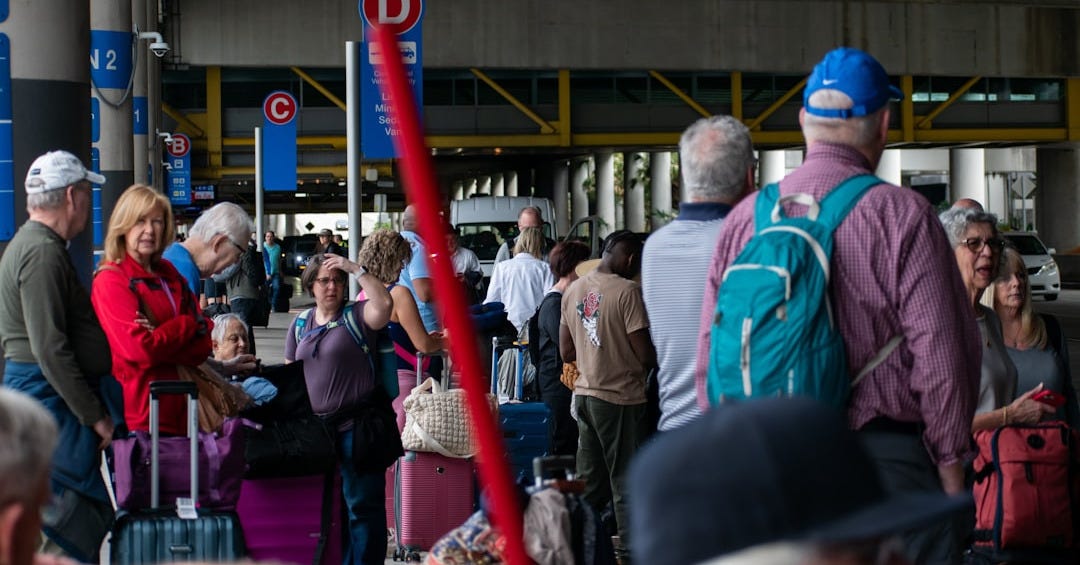 A group of people standing around with luggage
