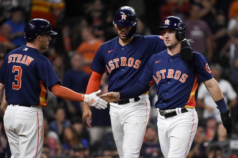 Houston Astros' Alex Bregman, right, celebrates scoring a run with Carlos Correa, center, and Myles Straw (3) during the eighth inning of a baseball game against the Texas Rangers, Sunday, May 16, 2021, in Houston. (AP Photo/Eric Christian Smith) Houston Astros' Alex Bregman, right, celebrates scoring a run with Carlos Correa, center, and Myles Straw (3) during the eighth inning of a baseball game against the Texas Rangers, Sunday, May 16, 2021, in Houston. (AP Photo/Eric Christian Smith)