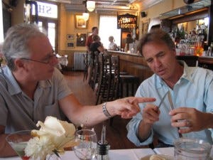 They talk as men about the pitch of the pergola. With wine.