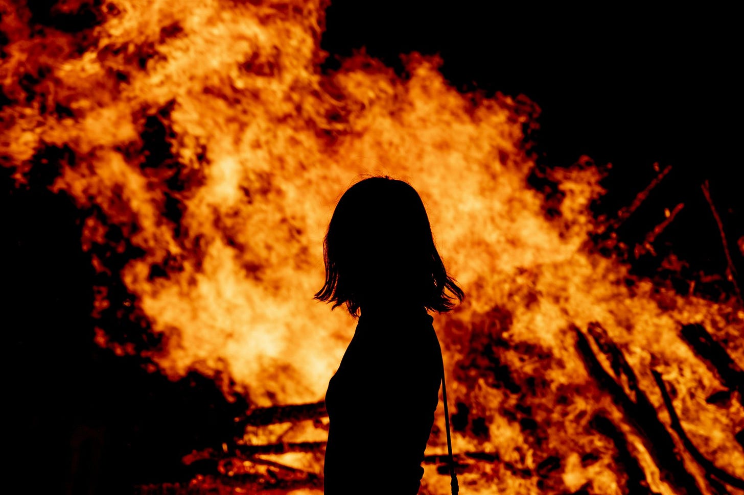 Woman in front of fire