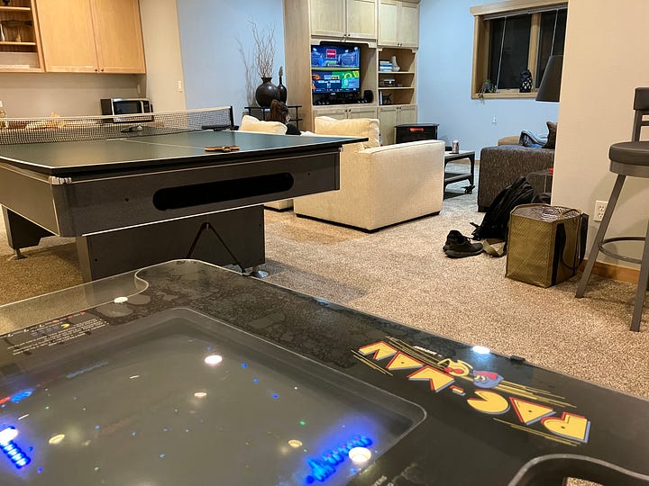 Ping pong, pool, Pac-Man, TV entertainment center, and dart board