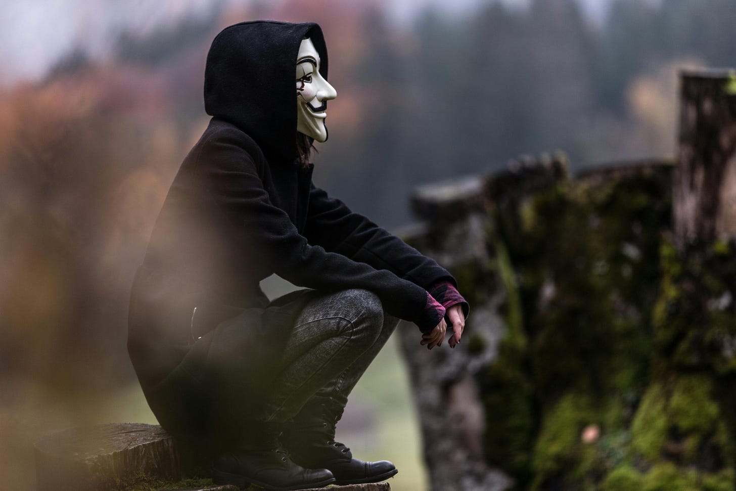 Man with mask sitting on a wall Man with mask sitting on a wall