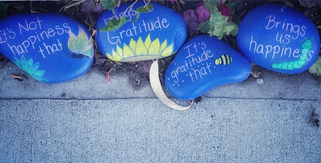 three painted rocks with words written on them