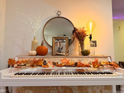 two pictures with a trunk full of different pumpkins, seventeen total. Another picture of a piano-altar, with Andrea's photos, autumnal garland, and pumpkins.
