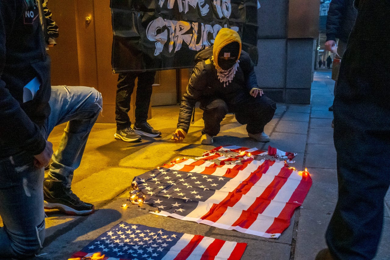 A protester burns an American flag in New York on Jan. 13. A protester burns an American flag in New York on Jan. 13.