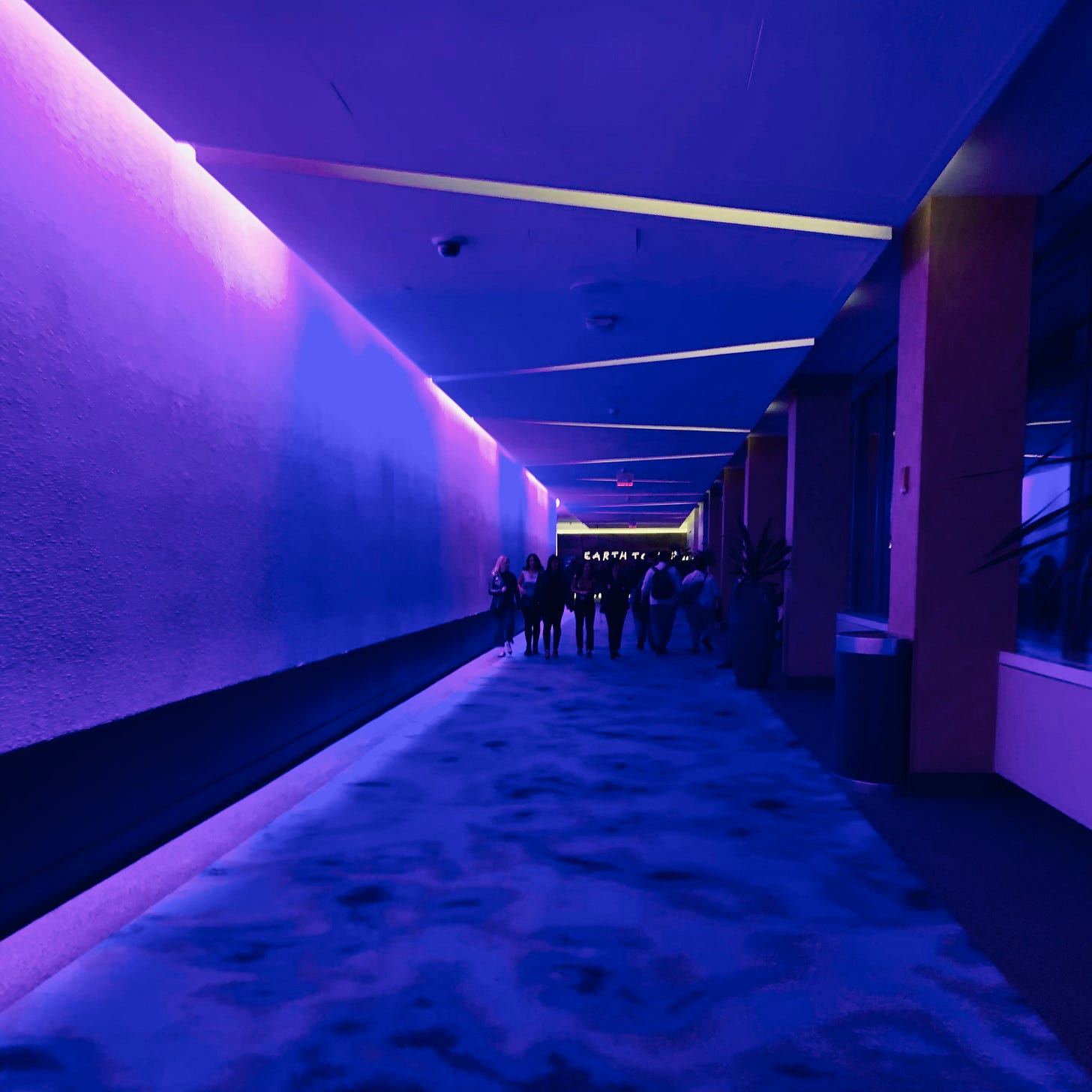 A long hallway bathed in purple light