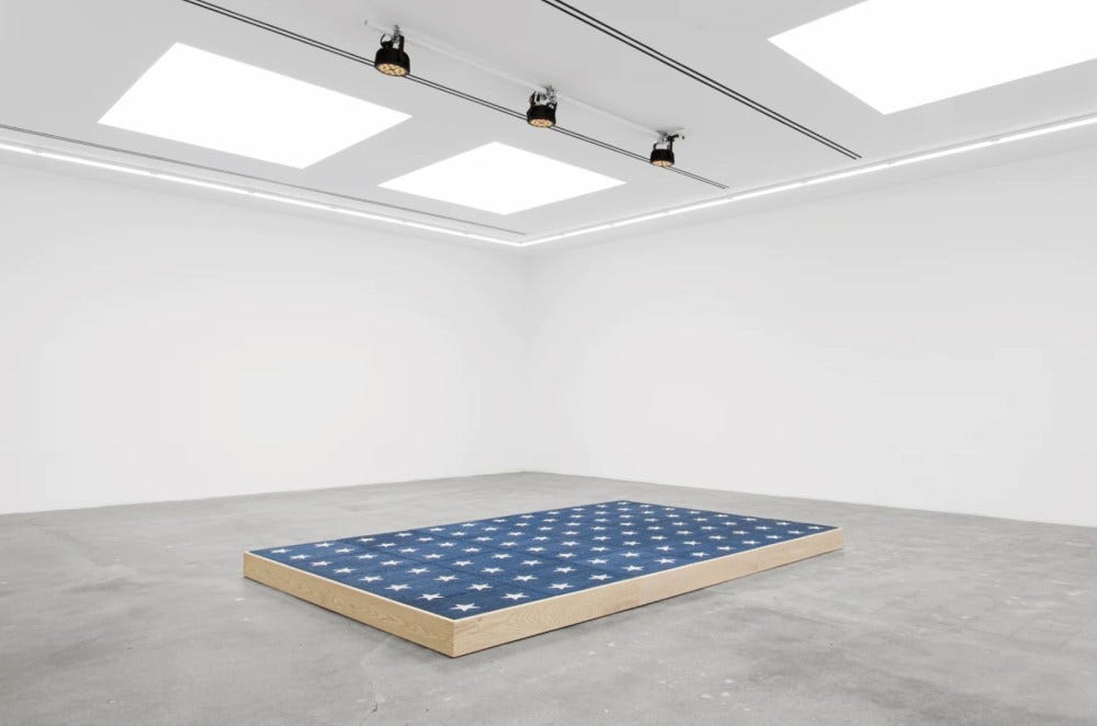 Jill Magid, The Platform (US General Elections, 2026), 2025, wood platform, dye-sublimated carpet, documents. Installation view.