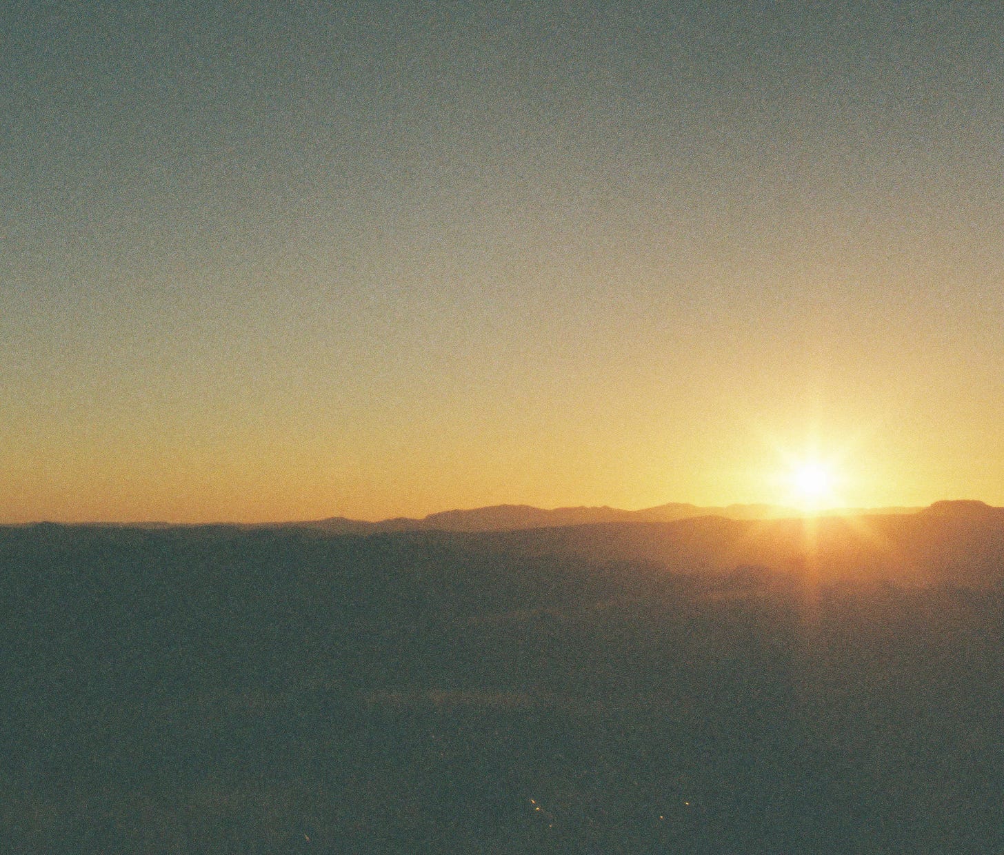 Sunrise over desert mountains