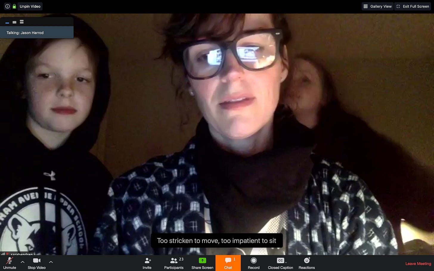 A screengrab from a video conference shows me typing captions, flanked by two children on my right and left. I'm typing the lyrics "too stricken to move, too impatient to sit," from a song called Tidewater by Jason Harrod.