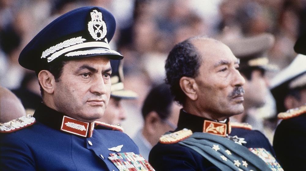 Egyptian President Anwar Sadat and Vice President Hosni Mubarak review a military parade commemorating the October War, 1981 Egyptian President Anwar Sadat and Vice President Hosni Mubarak review a military parade commemorating the October War, 1981