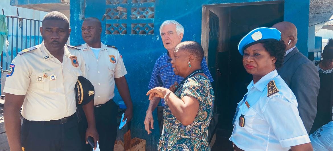  William O’Neill (centre background) visits a detention centre in Haiti.