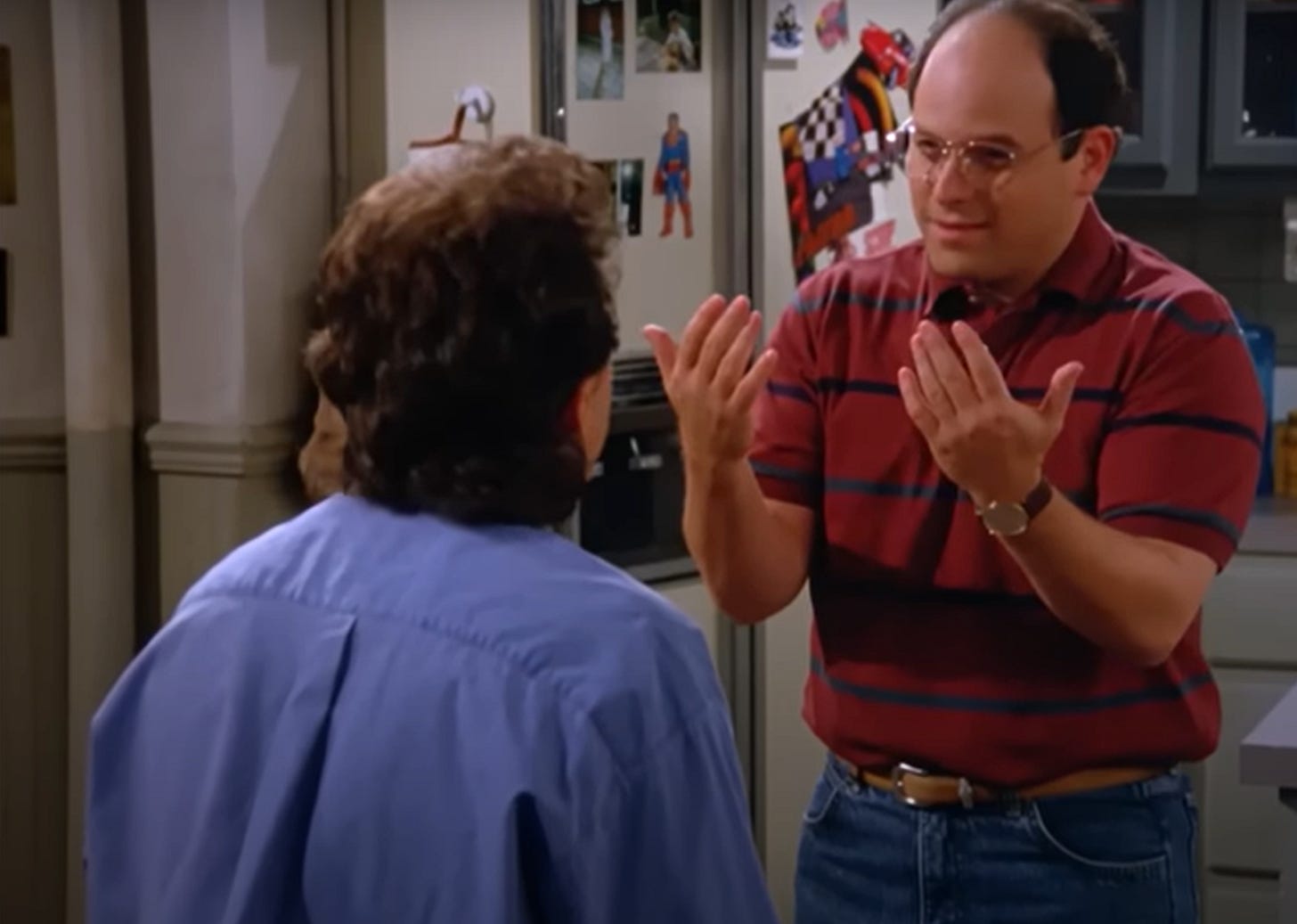 An image of George Costanza, a fictional character from the sitcom Seinfeld, holding up his hands in a screenshot from an episode about him becoming a hand model.