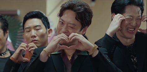 Three screenshots. One of the gang, the Wild Dogs who adopted Gu Won as their boss after he sent their boss to hell. One of Park Bok Gyu and Ms Shin when their relationship was discovered by Gu Won and Do Hee. And one f the office workers from the scene where Ms Shin revealed her relationship with Bok Gyu to them.