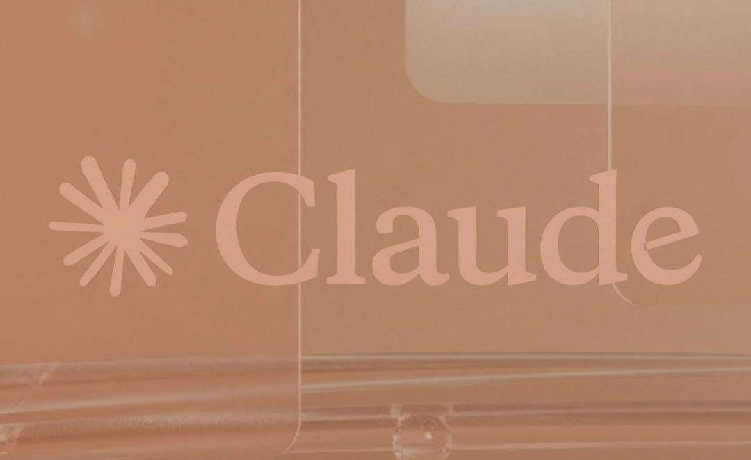 Claude logo on a light brown background with reflective surfaces. Claude logo on a light brown background with reflective surfaces.