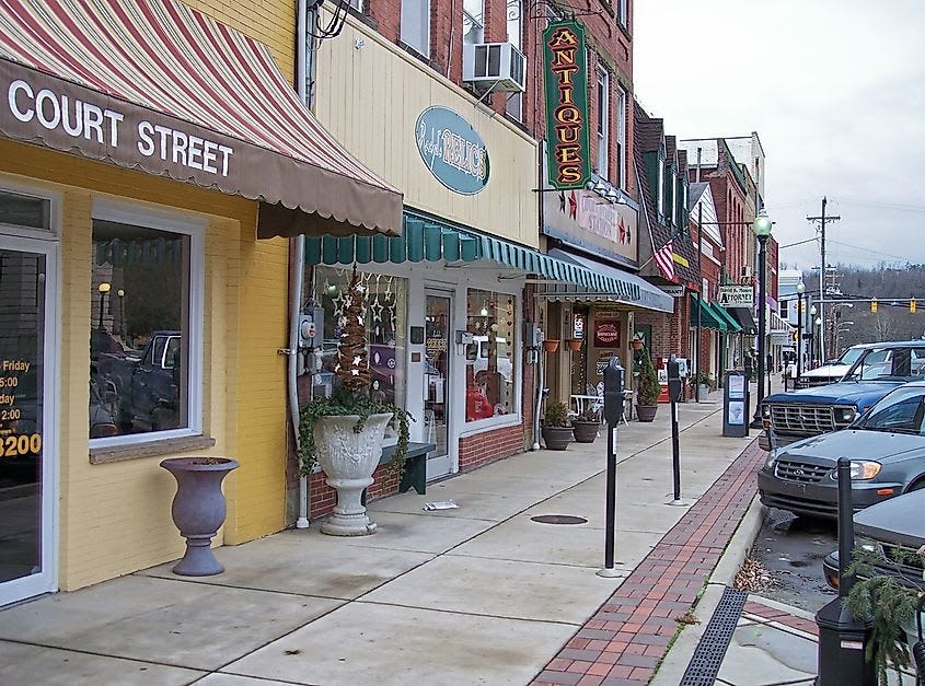 Local businesses and historic storefronts line a classic main street in a small West Virginia town