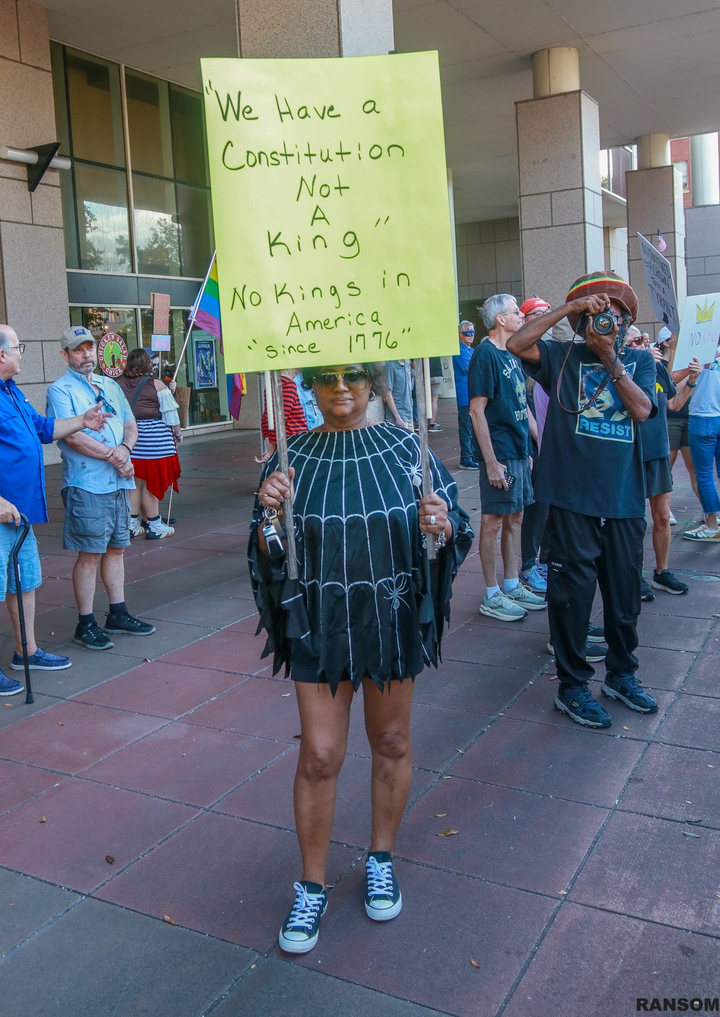 May be an image of crowd and text that says '"'We Have a Constitution Not A king No Kings in America since 1776 RESIST'