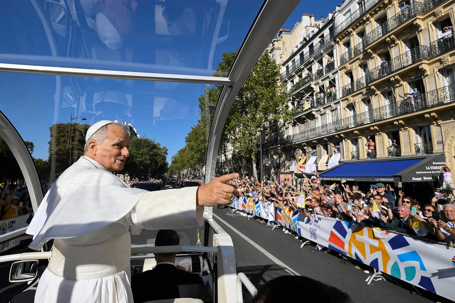 Pope Leo XIV waves to crowds from the popemobile in Paris Pope Leo XIV waves to crowds from the popemobile in Paris