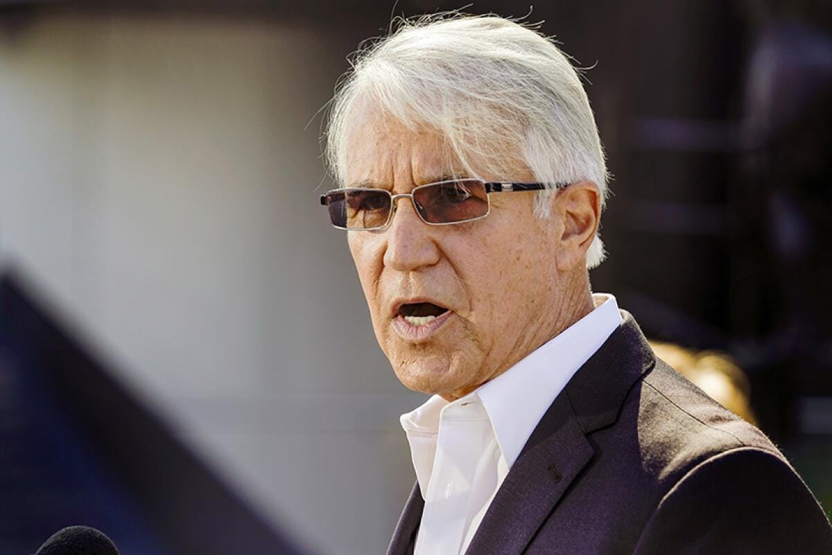 George Gascón talking in a suit