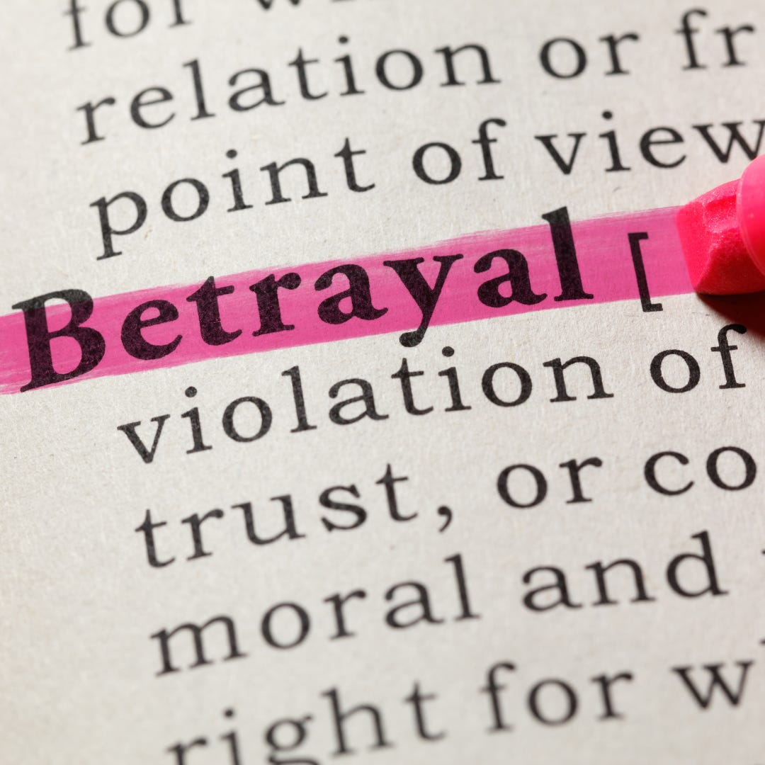 Dictionary with pink highlighted word "Betrayal."