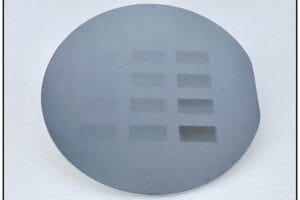A 10 cm silicon wafer with large visible patterns created using B-EUV lithography.