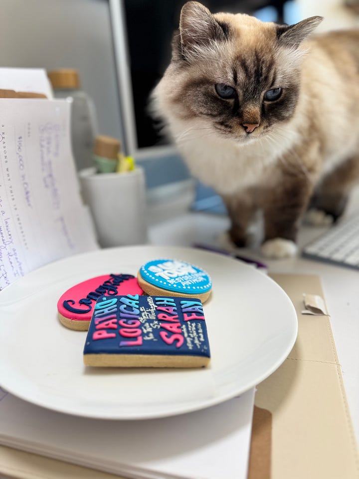 Sarah Fay, delighted, holding Pathological: The True Story of Six Misdiagnosis and the USA Today Best-selling Booklist. We did it! The cookies my team sent me from BBG. Sweets guarding the plate of cookies.