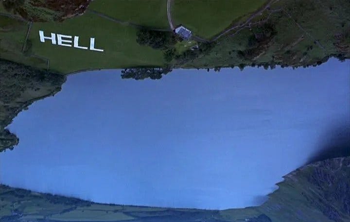 overhead shot of landscape with green fields and a pond. The word Hell is overlaid on a green field.