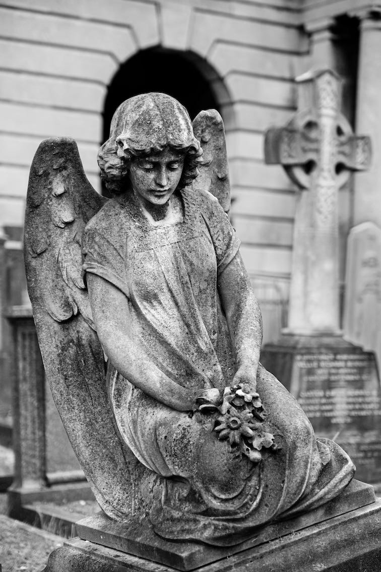 a statue of a sad angel