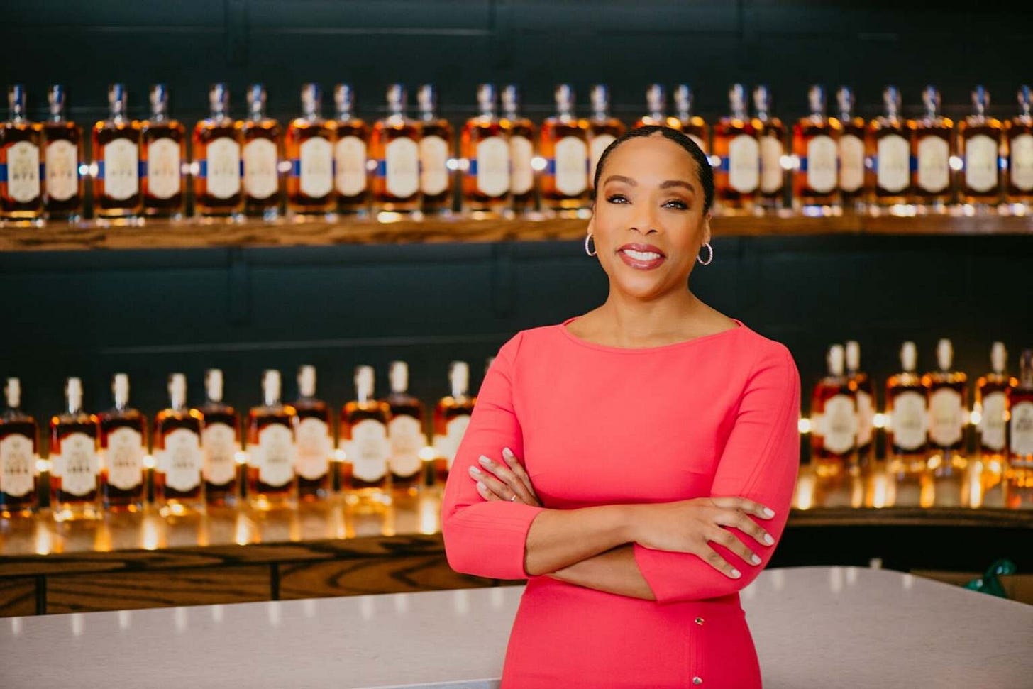Fawn Weaver, CEO of Uncle Nearest Premium Whiskey, stands in front of her product