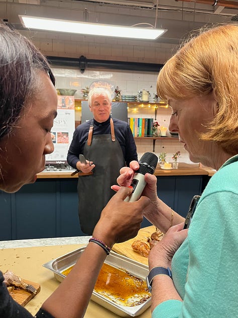 Paul Kelly of the Kelly Bronze company, standing behind a counter demonstrating carving technique.