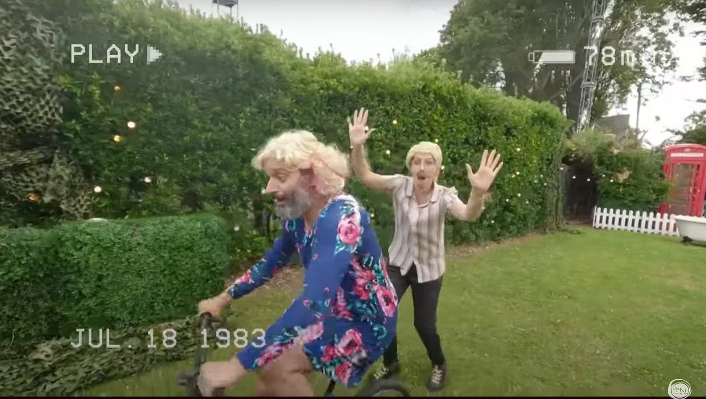 Stevie Martin as “Dad” runs behind Jason Mantzoukas as his daughter, as he rides a bike for the first time.